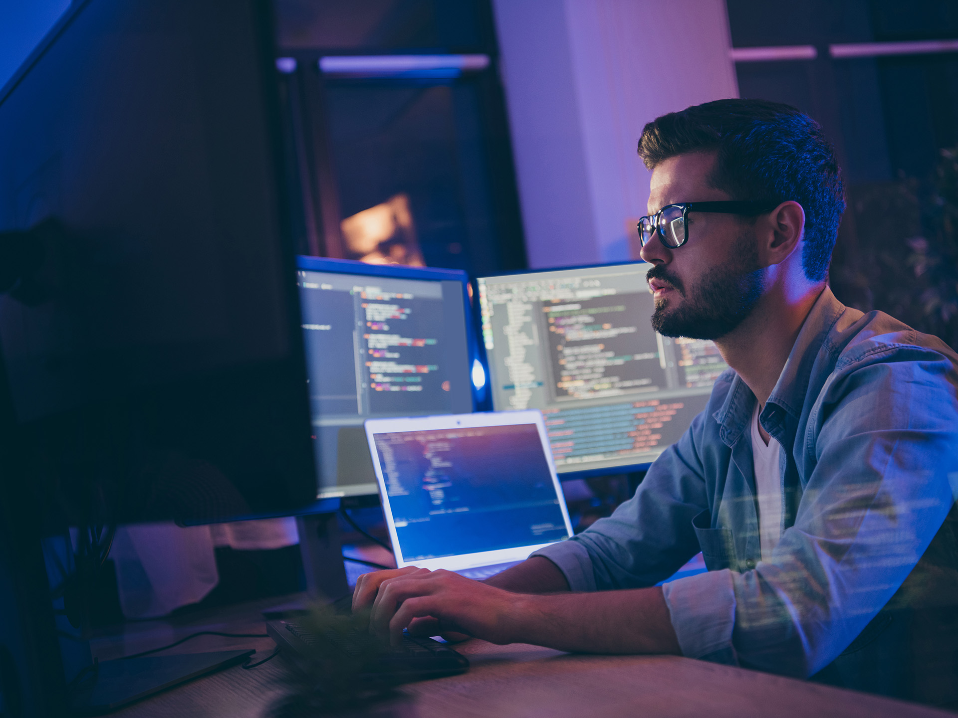 Man sitting at computer watching over network
